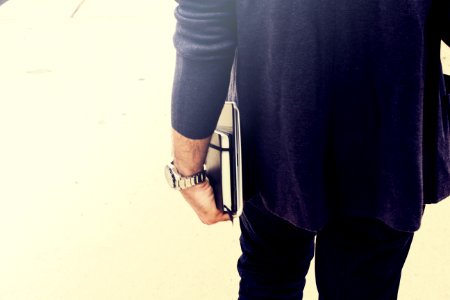 person holding books close-up photography