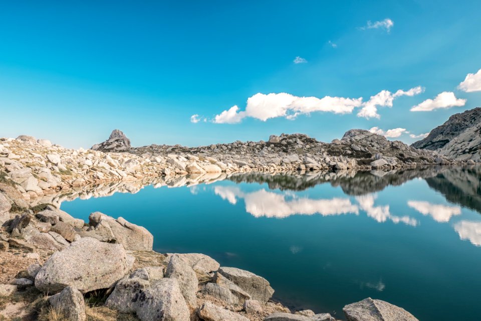 body of water surrounded by rock photo
