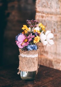 white and yellow petaled flowers in glass vase photo
