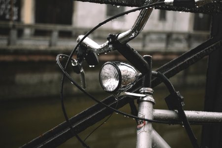 gray bicycle leaning on black metal fence at daytime photo