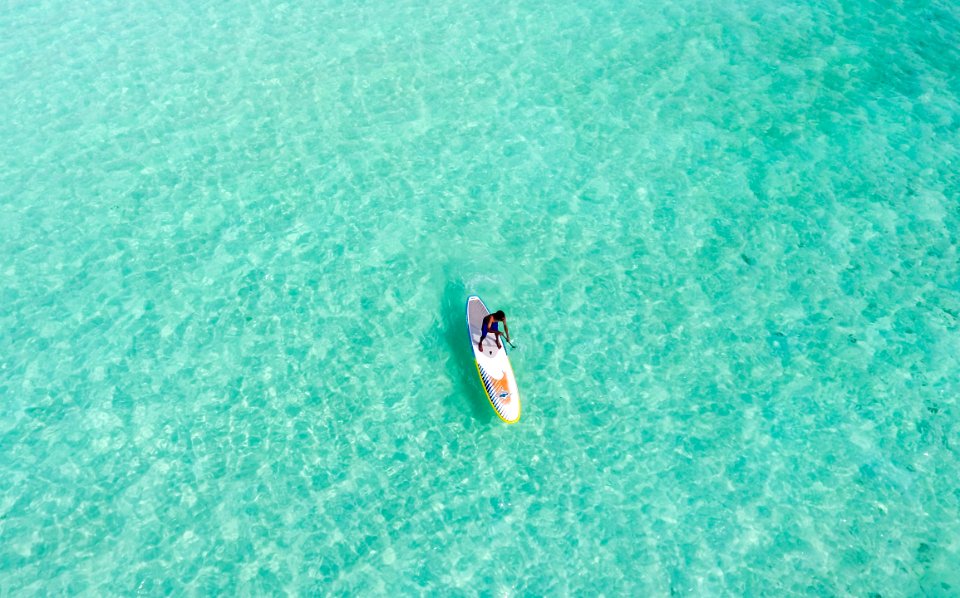 person riding on boat on large body of water during daytime