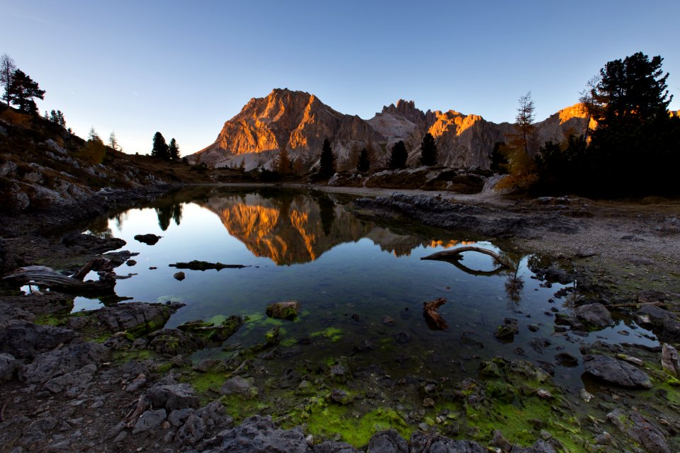 water mirror reflection of mountain during golden hour