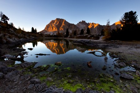 water mirror reflection of mountain during golden hour photo