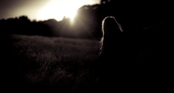 woman walking on grass field