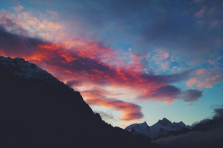 snow capped mountain under red clouds and blue sky photo