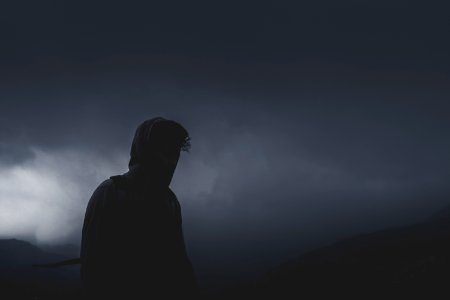 man looking forward on cloudy path photo