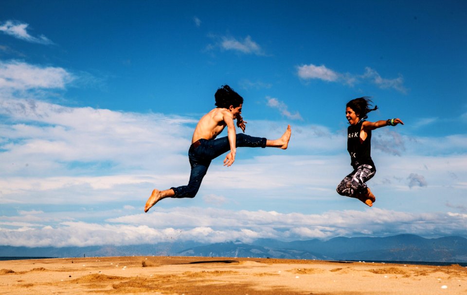 man and woman hanging on blue and white sky