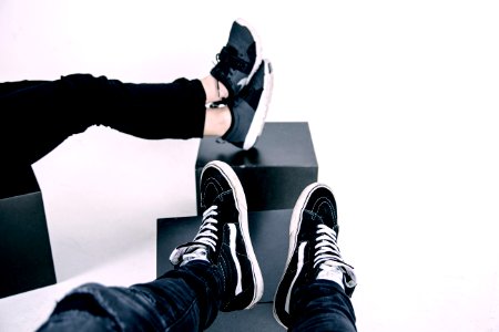 pair of white-and-black Vans high-top sneakers photo