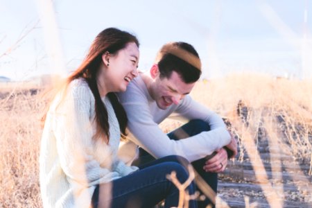 photo of man and woman laughing during daytime photo
