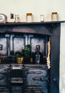 brown wooden kitchen shelf with ceramic jars on top