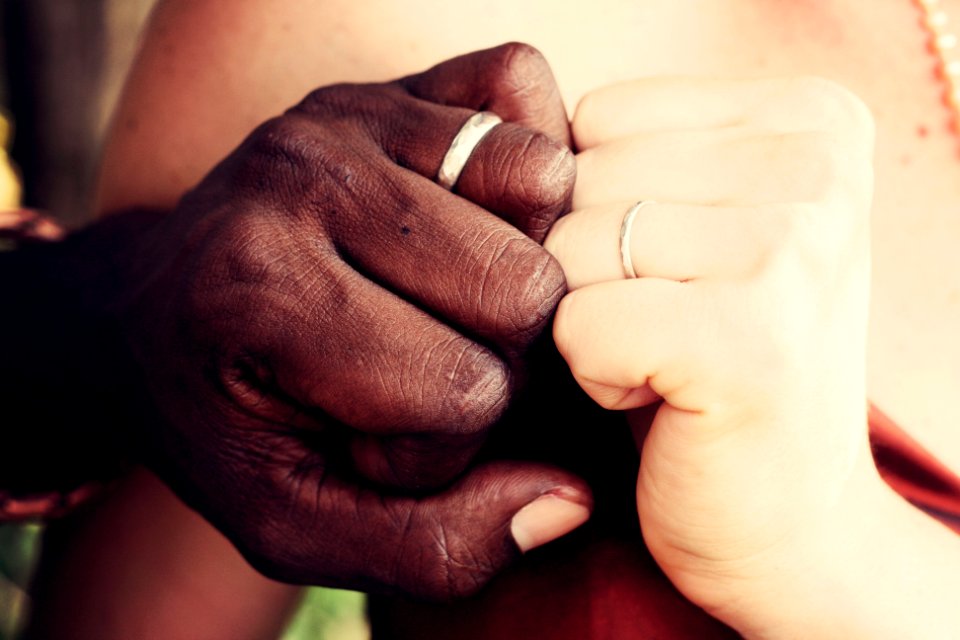 two person showing silver-colored rings