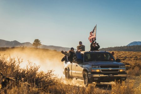 group of people riding silver Chevrolet extended cab photo