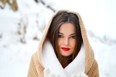 smiling woman with winter coat during daytime photo
