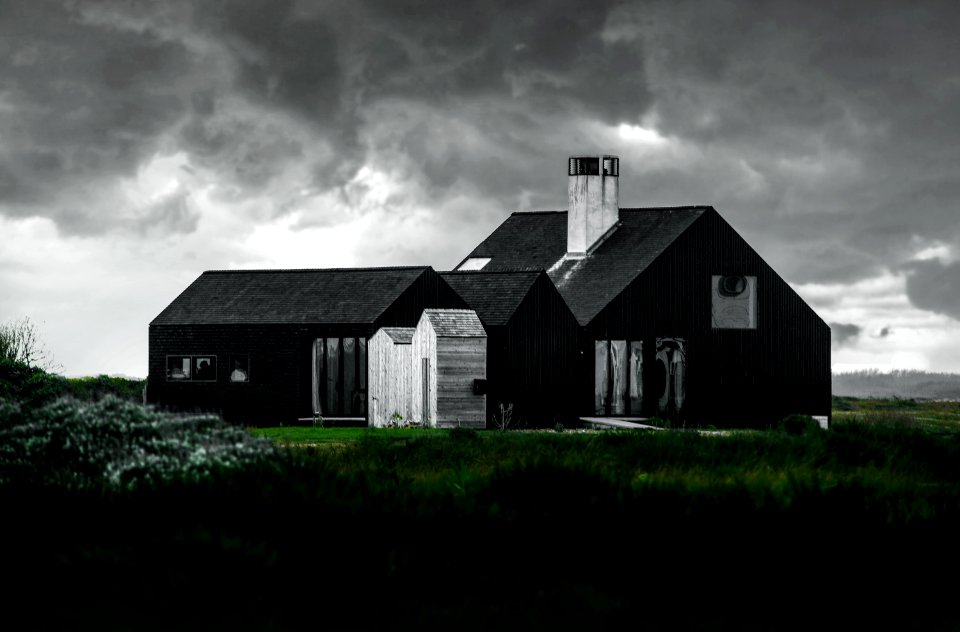black and white house beside green grass field