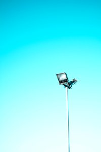 white and black light post under blue sky photo