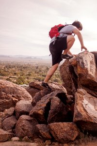man climbing mountain