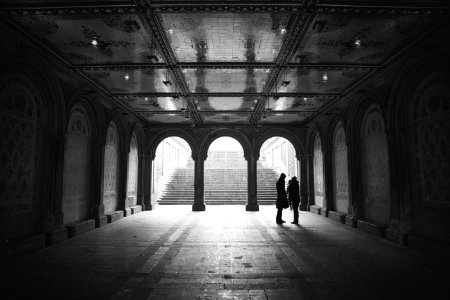grayscale two people standing on hallway photo