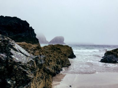 time lapse photography of seashore near boulder photo