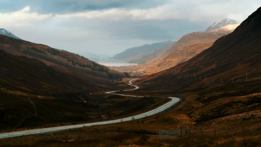 concrete road surrounded by mountains photo