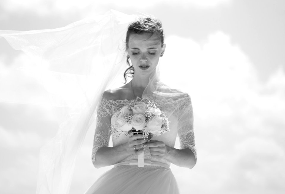 grayscale picture of bride holding flower bouquet