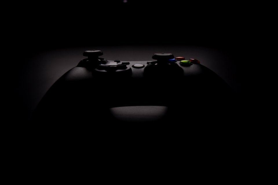shallow focus photography of black Xbox controller