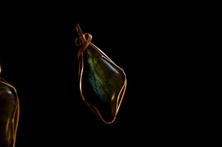green gemstone wire wrap pendant with black background