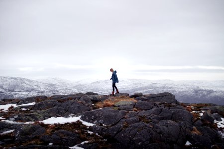 man standing on mountain during daytime photo