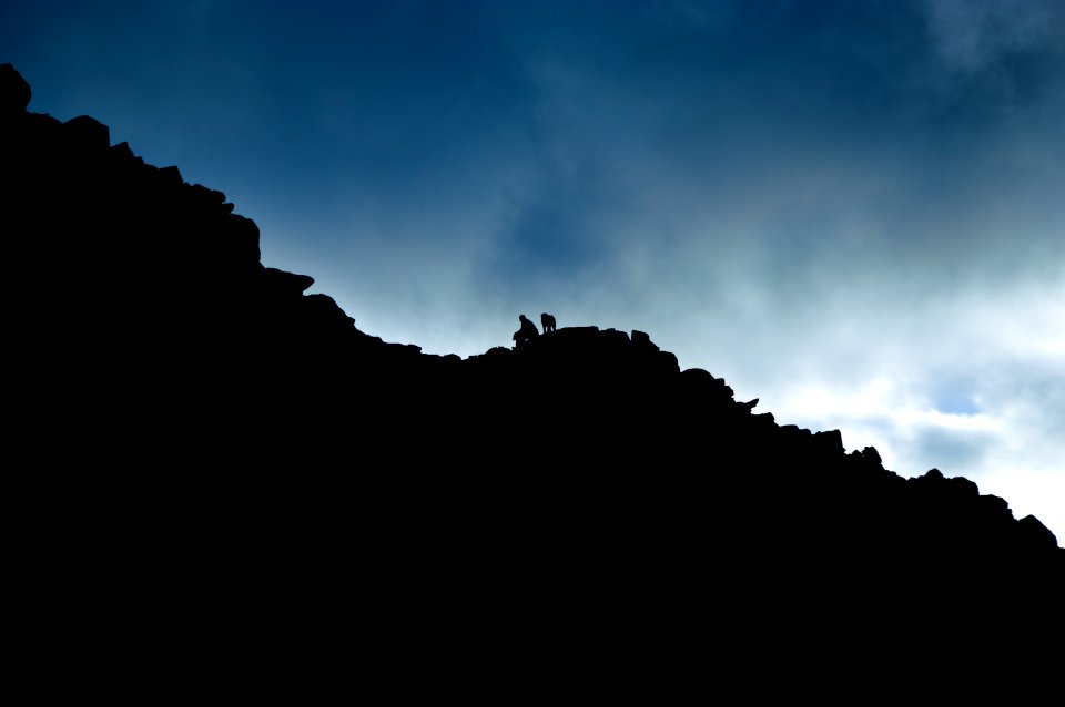 low angle of person on rock cliff