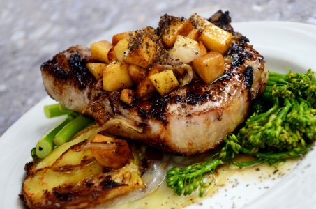 grilled steak with vegetables on white ceramic plate photo