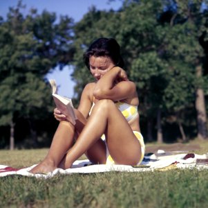 woman sitting on mat reading book photo