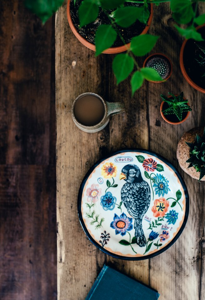 top view photo of black and multicolored bird painting with flower theme