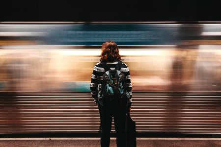 person standing in front of train station photo