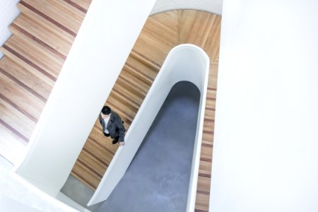 person stepping down on brown wooden stairs aerial photography photo