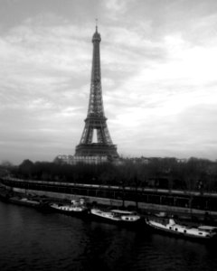 grayscale photo of Eiffel tower and boats docked near pier photo