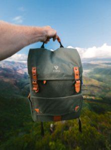 person holding black and brown Vinta backpack photo
