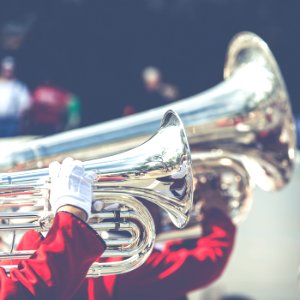 close up photo of person playing horn instrument photo