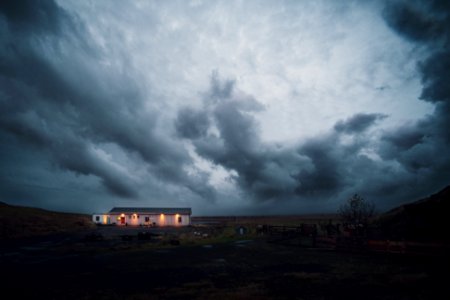 cloudy sky over lighted house photo