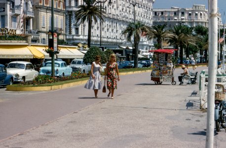 two women walking on street photo