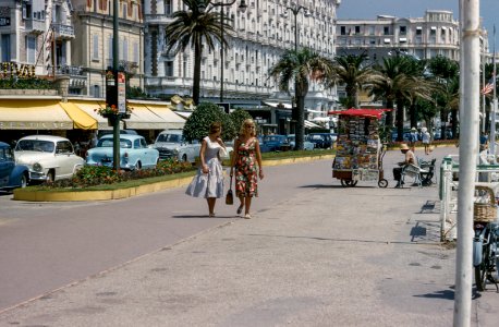 two woman walking on side walks