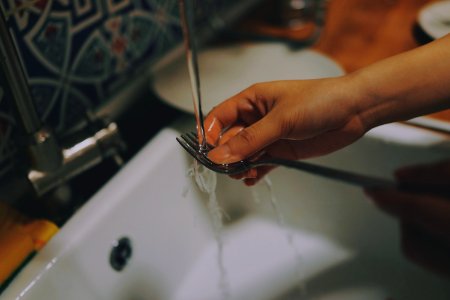 person washing fork photo