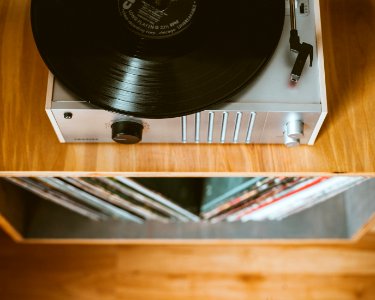 gray turntable on brown wooden table photo