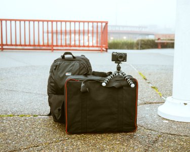 camera mounted on tripod on top of luggage bag photo