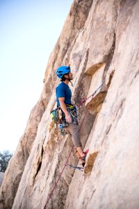 man doing rock climbing at daytime photo