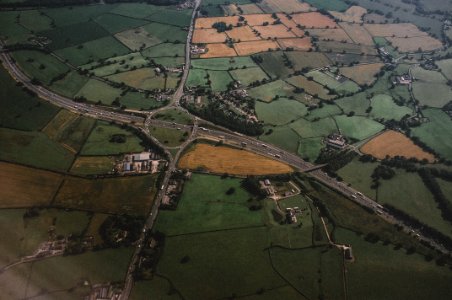 aerial photography of concrete roadway and green field photo