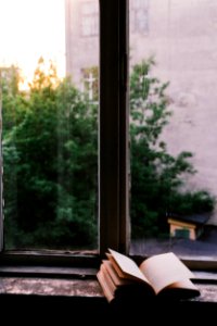 book near glass window photo