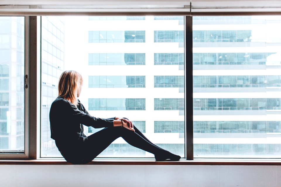 woman sitting on window