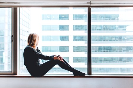 woman sitting on window