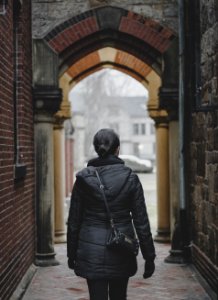 person standing on alleyway during daytime