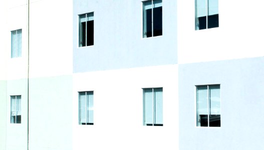 white and gray concrete wall with windows photo