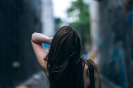 selective focus photography of woman waving her hair photo